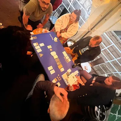 People playing cards at outdoor table