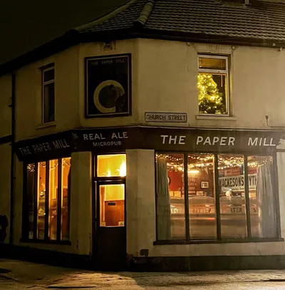 Pub exterior at night with warm lighting