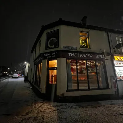 Snowy evening view of pub exterior