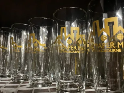Row of branded Paper Mill glasses