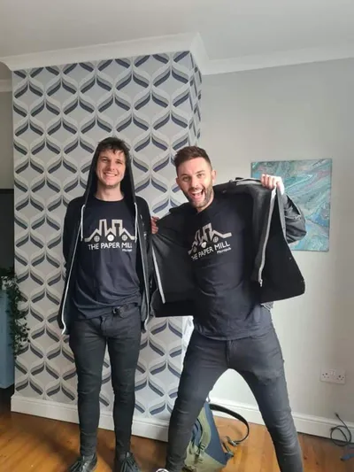 Two men wearing papermill hoodies